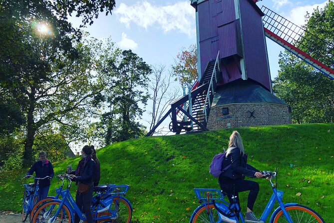BikeTour Bruges & Damme in Spanish and English - Four Bruges windmills beside the canal