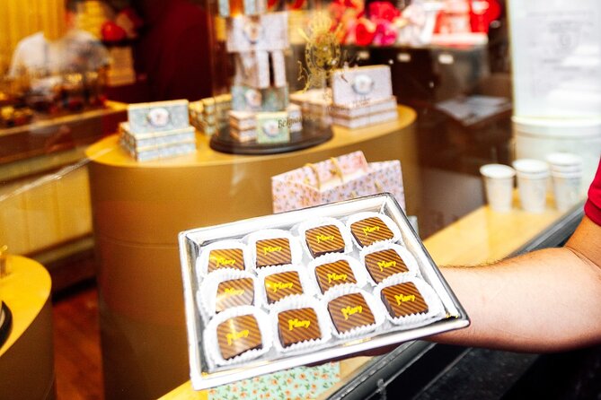 Brussels: Historical Walking Tour with Chocolate & Waffle Tasting - Manneken Pis, with a waffle in hand