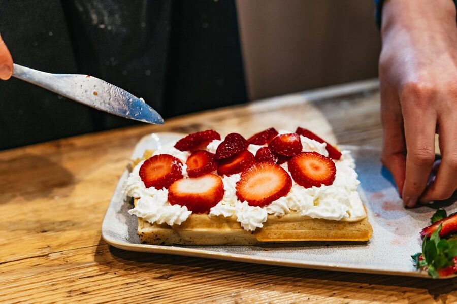 Brussels: Waffle Making Workshop - All You Can Eat - The topping table: chocolate, cream, honey, and fruit